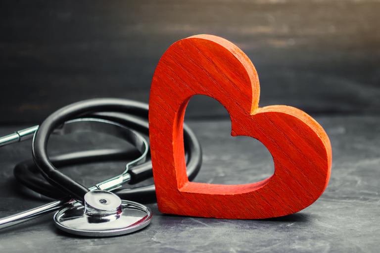 a wooden heart and a stethoscope